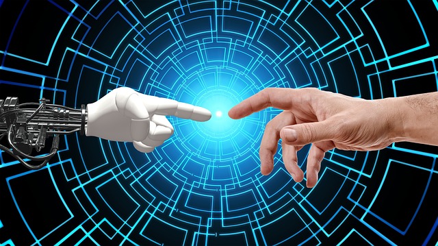 human hand coming from the left of the screen with his index finger pointed left, a robot arm and hand coming from the left, with index finger point to the right. Both fingers are about one inch from touching.
