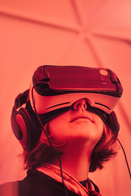 Girl wearing a VR headset, there is a red hue to the overall image.