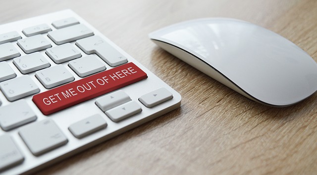 Close up of a keyboard and mouse, the keyboard's keys are white except one big key labelled 