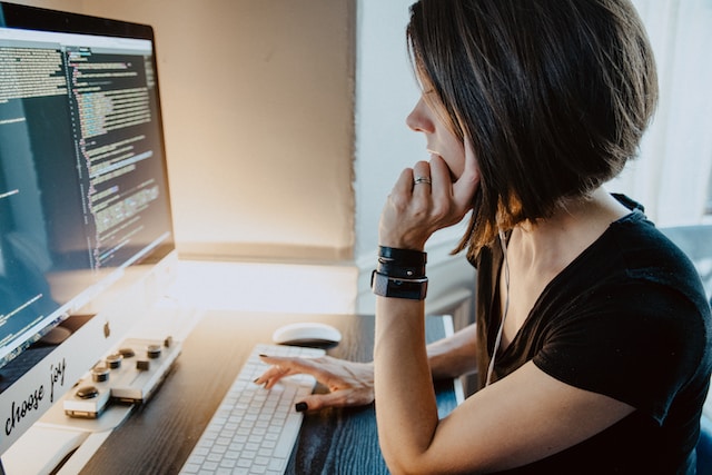 Woman sitting at a desk programming.