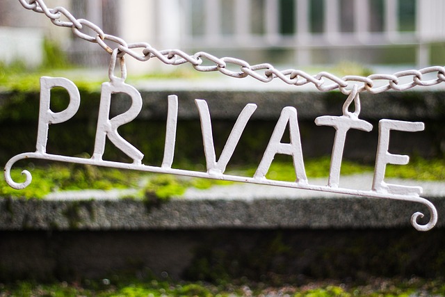 Private sign hanging from a chain outside someone's house.